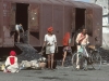 Scene at Bhavnagar on 13 January 1981, as coal is unloaded by mainly female labour.  Why are covered vans used for transporting coal to engine sheds?  To prevent the coal from being stolen en route.