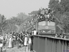 Bangladesh: Auf dem Heimweg. Sobald der Zug die Brücke passiert hat, setzen die Fußgänger ihren Marsch entlang der Gleise fort.